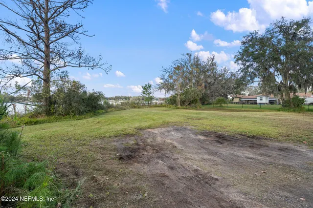 a view of a field of grass and trees