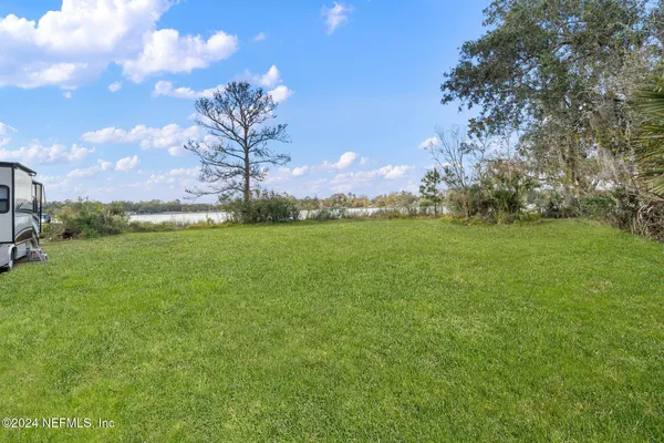 a view of lake with green space