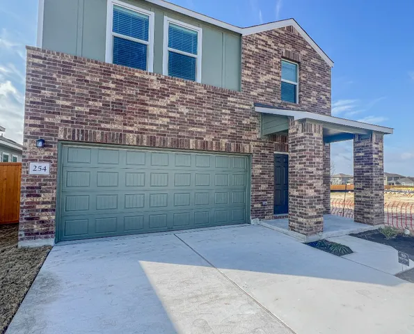 a view of a brick house with large windows