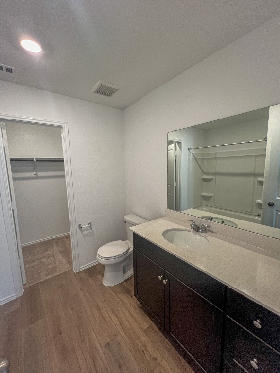 254 The Bad Way Jarrell, TX 76537 - Photo 15 of 24 a spacious bathroom with a granite countertop sink toilet and shower