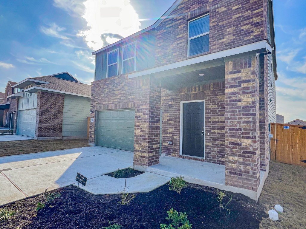 254 The Bad Way Jarrell, TX 76537 - Photo 2 of 24 a front view of a house with garden