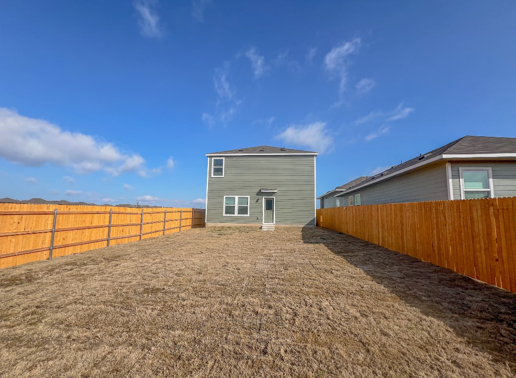 254 The Bad Way Jarrell, TX 76537 - Photo 23 of 24 a view of backyard with wooden fence