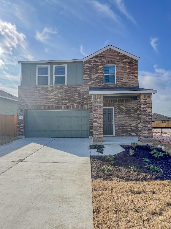 254 The Bad Way Jarrell, TX 76537 - Photo 3 of 24 a front view of a house with garden