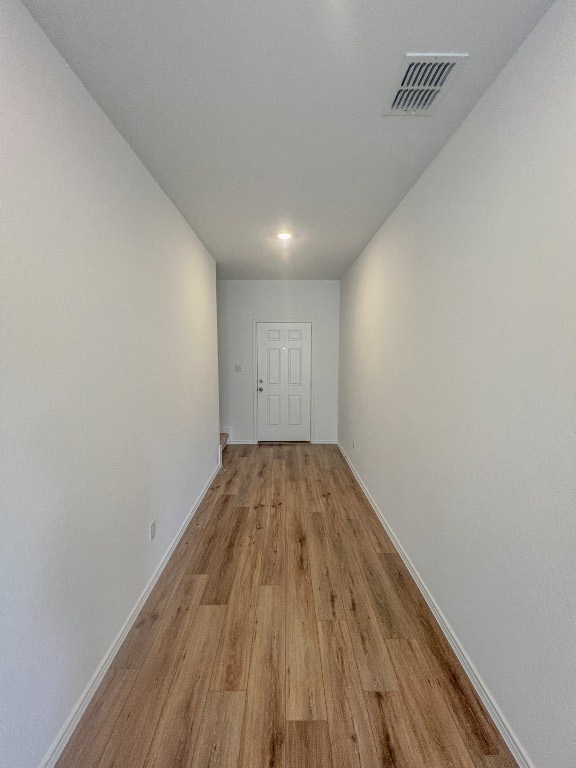 254 The Bad Way Jarrell, TX 76537 - Photo 6 of 24 a view of empty room with wooden floor