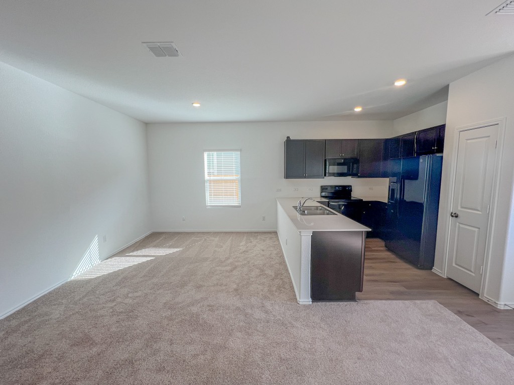 254 The Bad Way Jarrell, TX 76537 - Photo 24 of 24 a view of kitchen and kitchen with windows