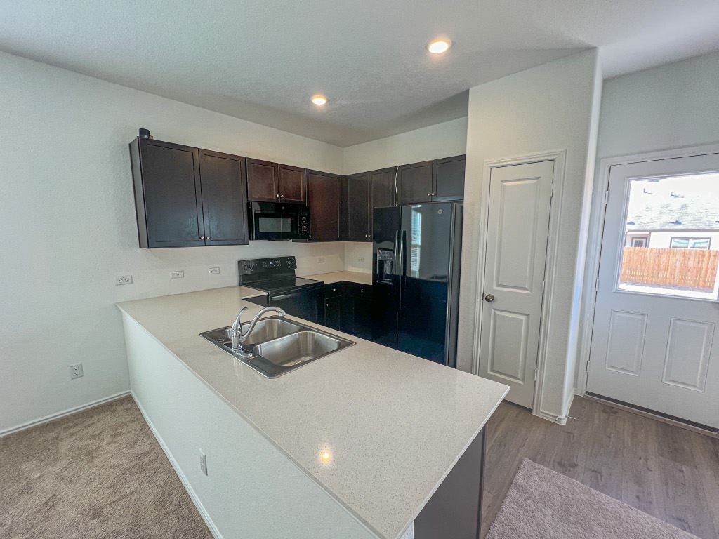 254 The Bad Way Jarrell, TX 76537 - Photo 8 of 24 a kitchen with a sink a stove and refrigerator