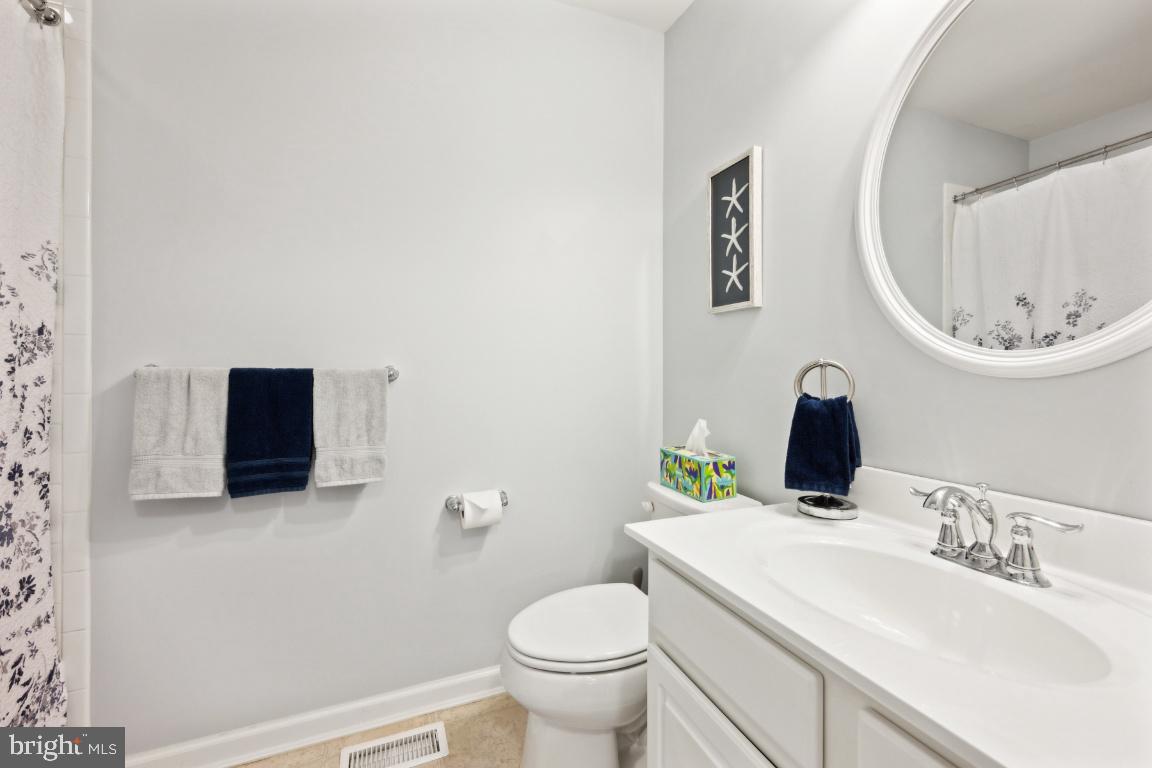12 Wallace Road Mount Holly, NJ 08060 - Photo 15 of 25 a bathroom with a toilet a sink and mirror