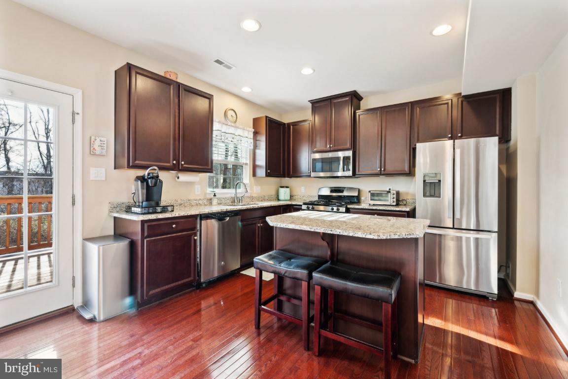 12 Wallace Road Mount Holly, NJ 08060 - Photo 7 of 25 a kitchen with kitchen island granite countertop wooden floors appliances and sink