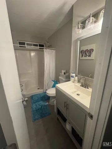 a bathroom with a sink a mirror and a shower