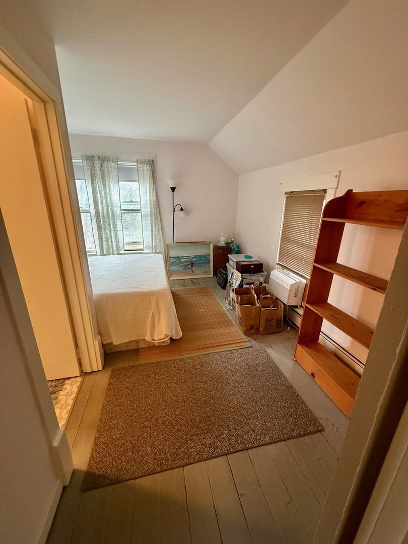742 South 4th Street DeKalb, IL 60115 - Photo 24 of 46 a bedroom with a bed and wooden floor