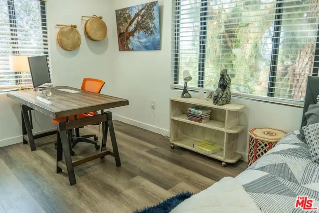 a view of a workspace with furniture and window