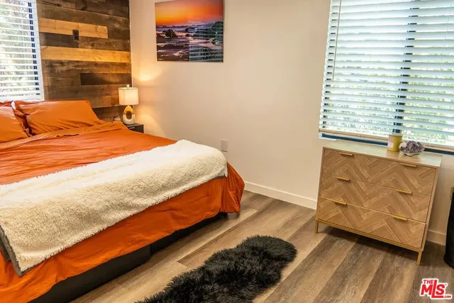 a bedroom with a bed and a mirror