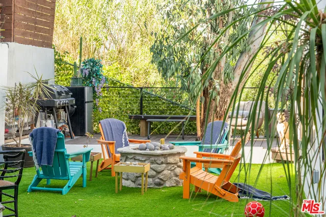 a sitting area with furniture and wooden floor