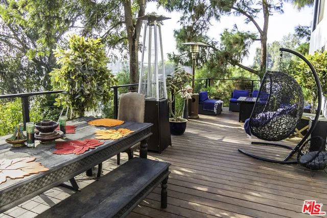 a balcony with furniture and a potted plant