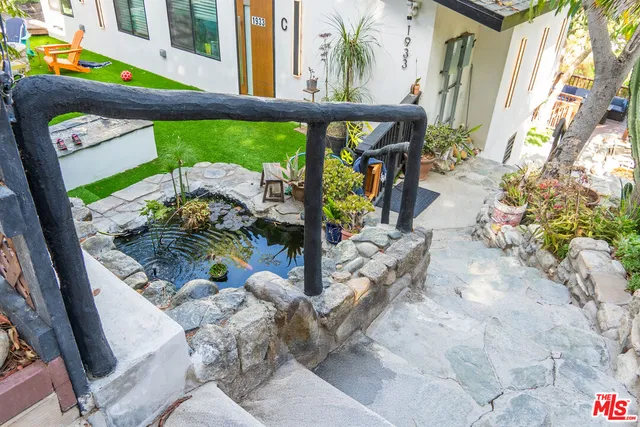 an aerial view of residential houses with outdoor space and trees