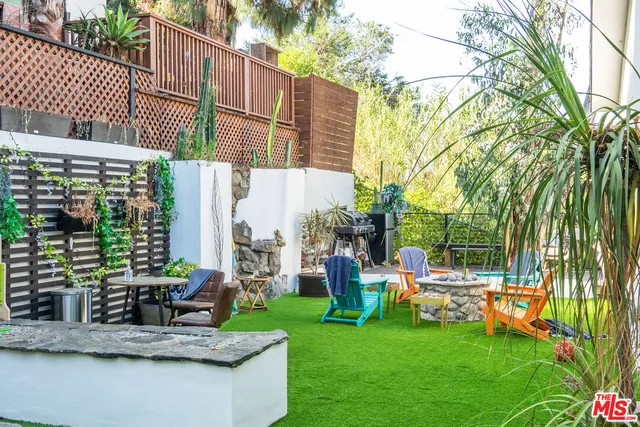 a view of a chairs and table in backyard