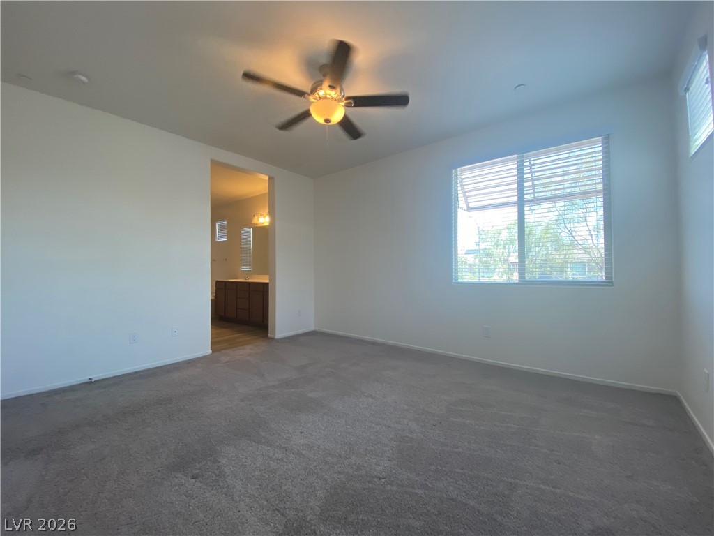 436 Cadence View Way Henderson, NV 89011 - Photo 18 of 36 A quiet bedroom retreat with a window overlooking the surroundings and direct access to a private bath.