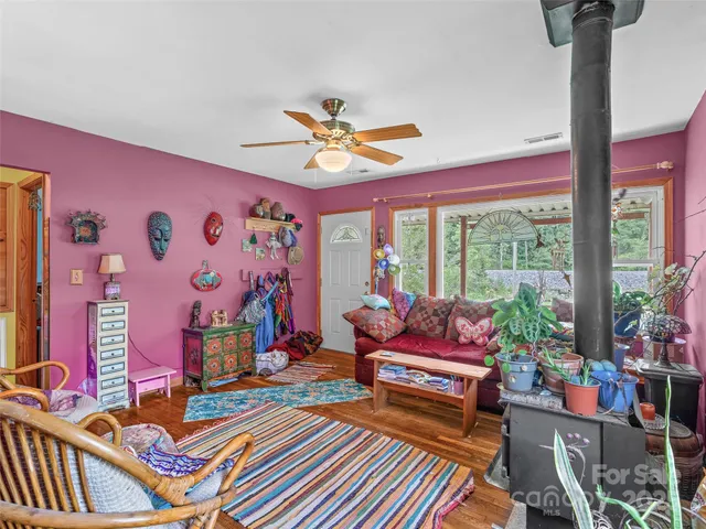 a living room with patio furniture and a floor to ceiling window