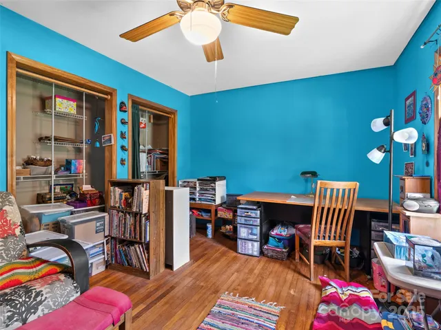a bedroom with furniture and a baby crib