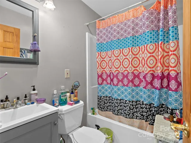 a bathroom with a sink mirror and toilet