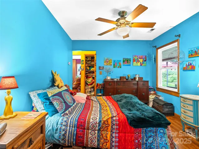 a bed room with two bed and a window