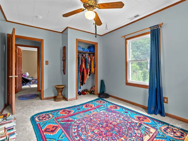 a bedroom with bed and a window