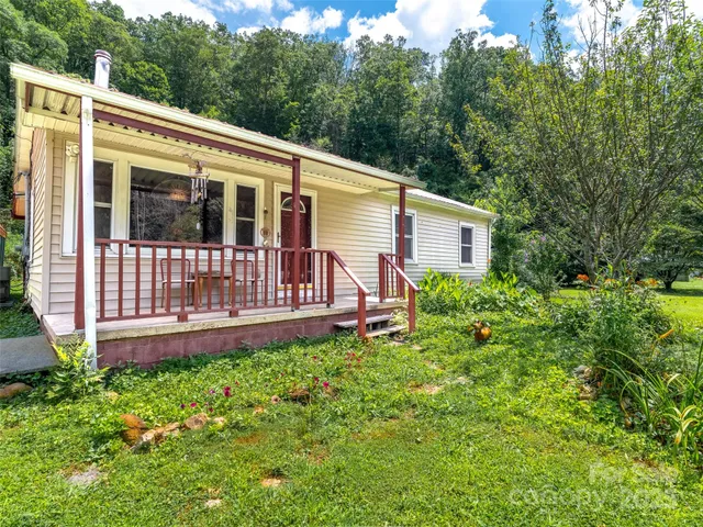 a view of a house with a yard and a garden