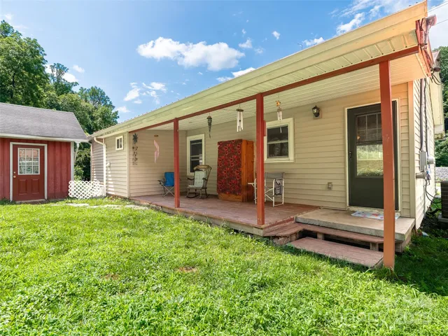 a view of a backyard with plants and a patio
