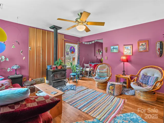 a living room with furniture a rug and a window