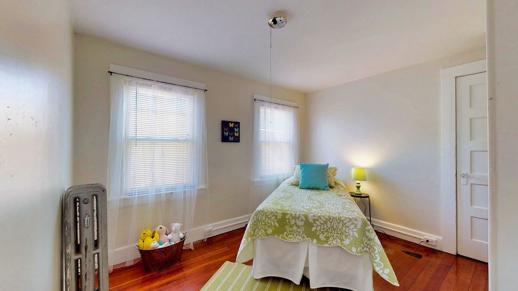 43 Longfellow Terrace Springfield, MA 01108 - Photo 23 of 25 a bedroom with a bed and wooden floor