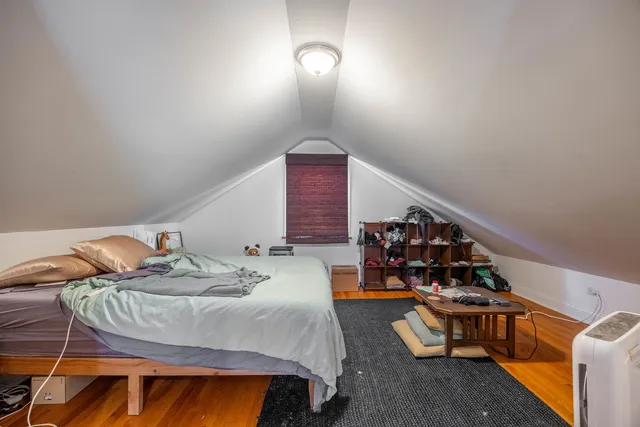 a bedroom with a bed and a large window