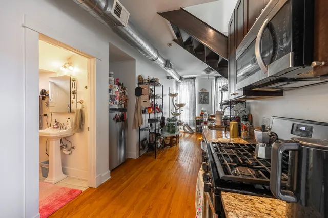 a living room with furniture a couch and wooden floor