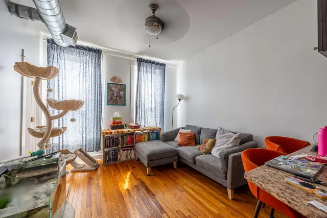 a living room with blue lights with furniture