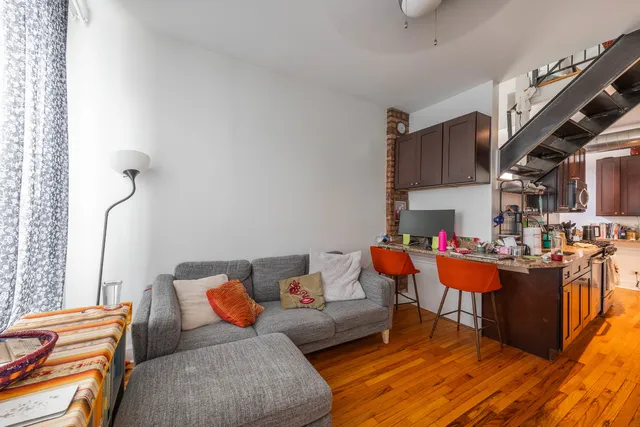 a living room with furniture and a book shelf