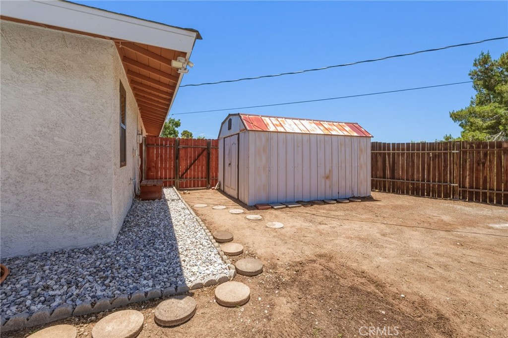 16230 St Timothy Road Apple Valley, CA 92307 - Photo 51 of 51 Side of house and shed