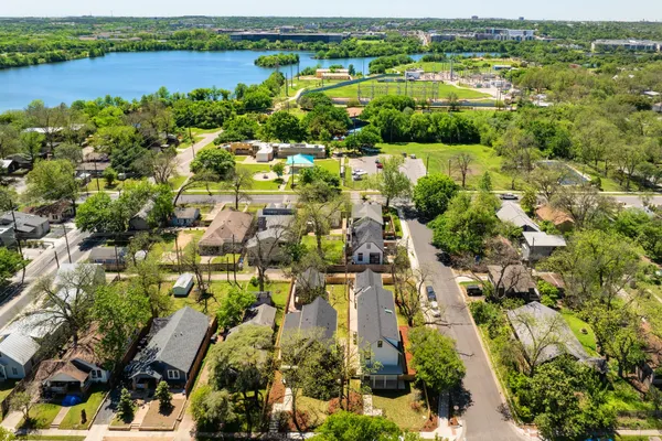 an aerial view of residential houses with outdoor space and river