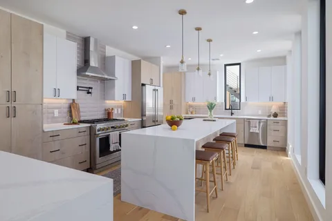 a kitchen with stainless steel appliances granite countertop a sink stove and refrigerator