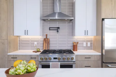a kitchen with a sink stove and cabinets