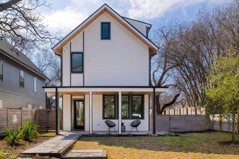 a view of a house with backyard porch and sitting area