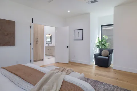 a bathroom with a tub a sink and mirror