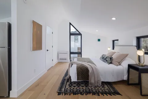 a bathroom with a toilet a sink a mirror and vanity