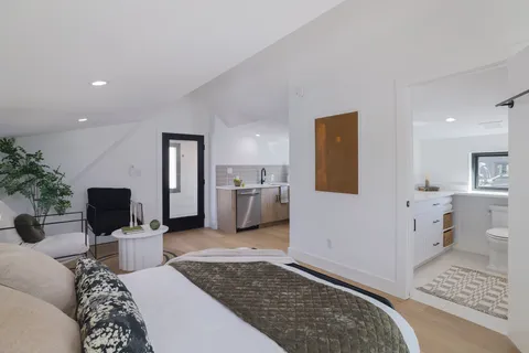 a view of a house with backyard and a tree