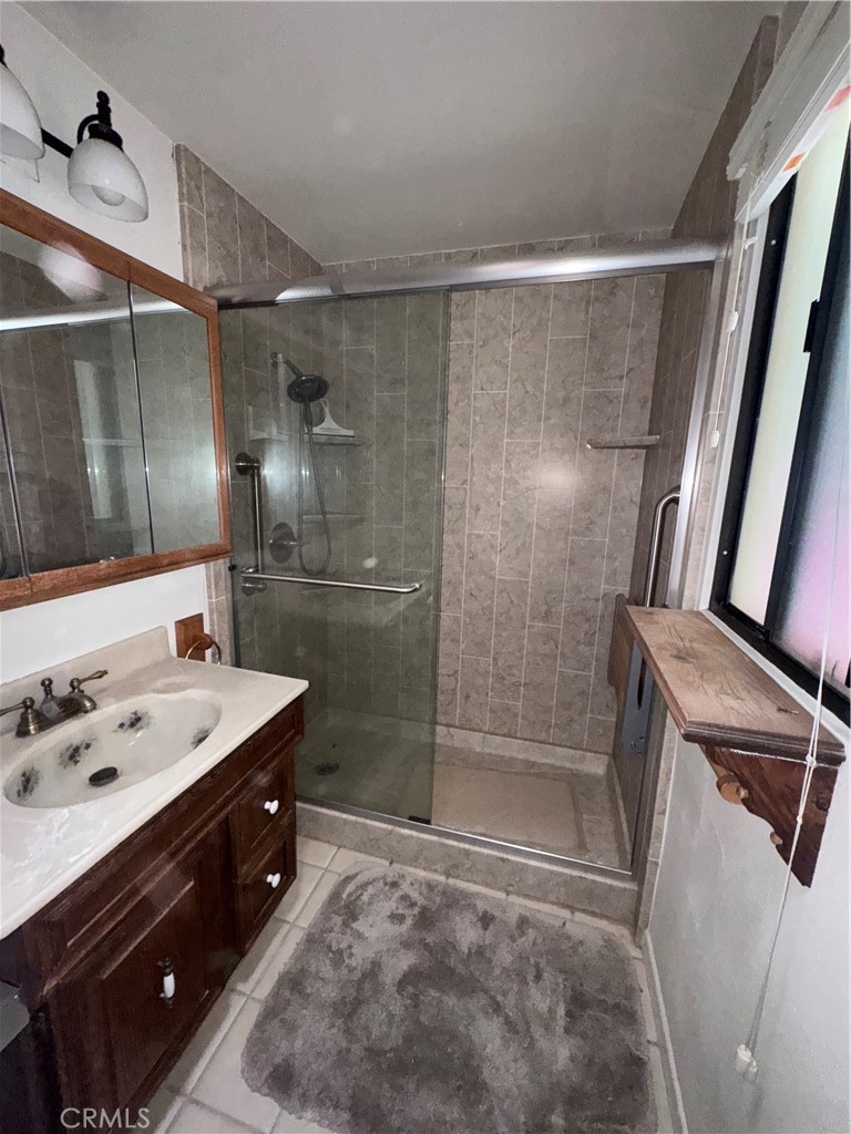 19509 Stagg Street Reseda, CA 91335 - Photo 8 of 9 a bathroom with a sink mirror and shower