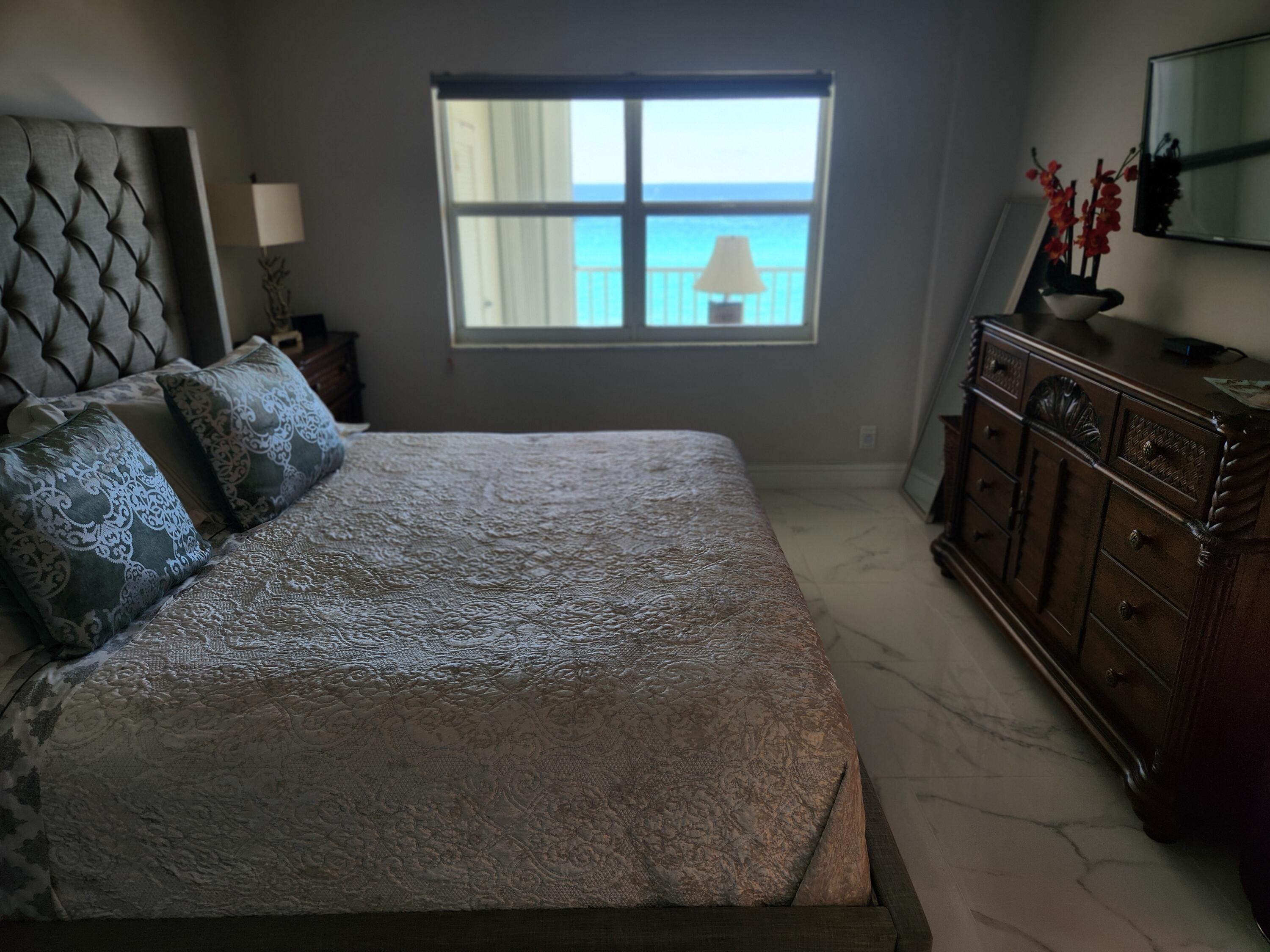 3101 South Ocean Boulevard, Unit 812 Highland Beach, FL 33487 - Photo 12 of 24 a bedroom with a bed and a window