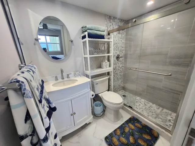 a bathroom with a sink toilet and shower