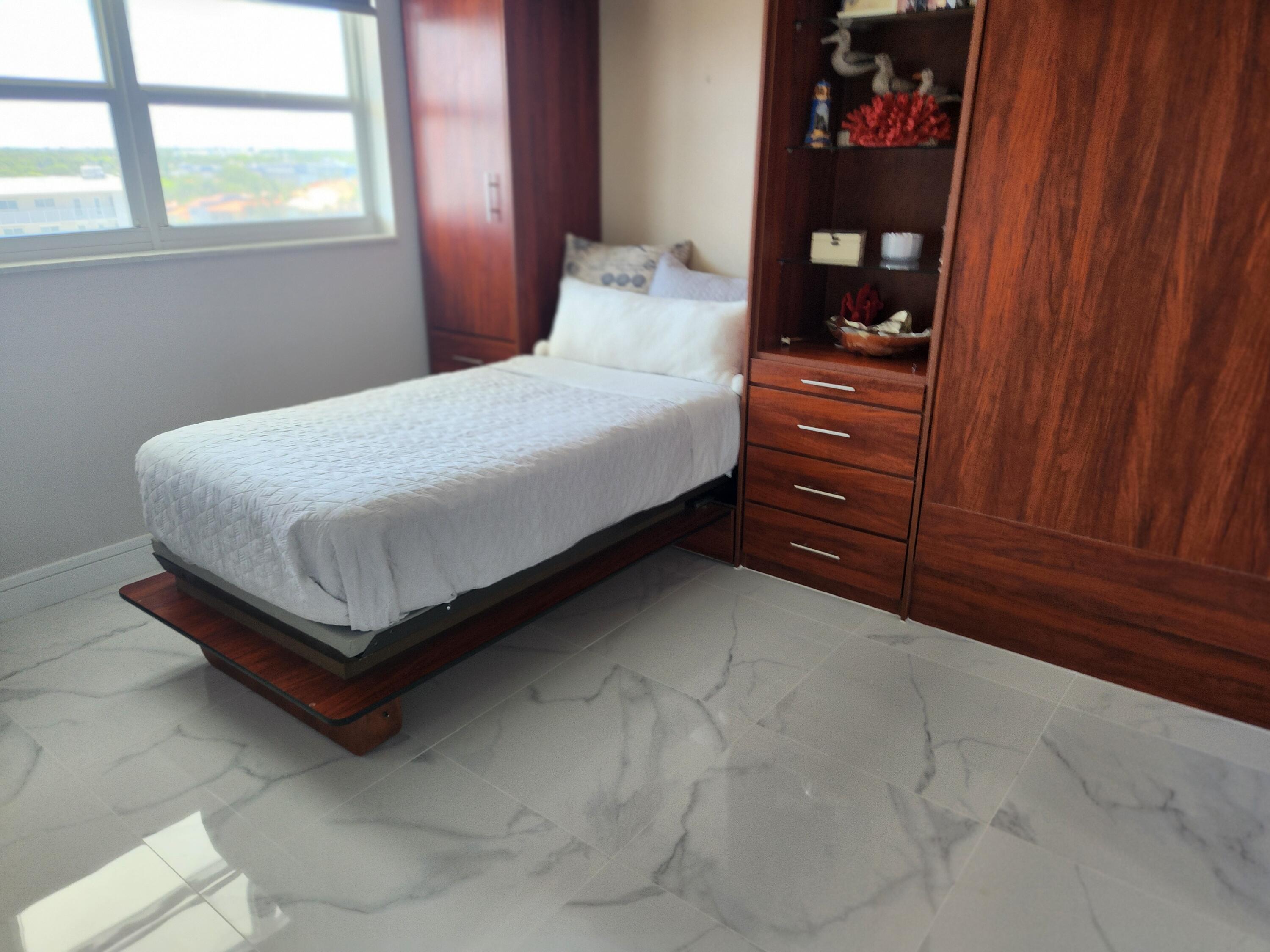 3101 South Ocean Boulevard, Unit 812 Highland Beach, FL 33487 - Photo 14 of 24 a bedroom with a bed and closet