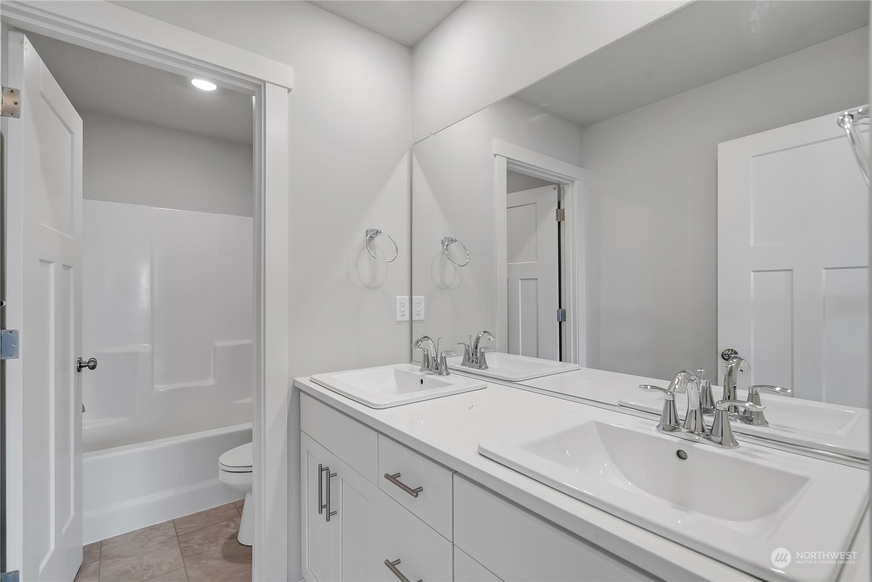 2719 South 9th Circle Ridgefield, WA 98642 - Photo 4 of 16 a bathroom with a granite countertop sink a toilet and shower