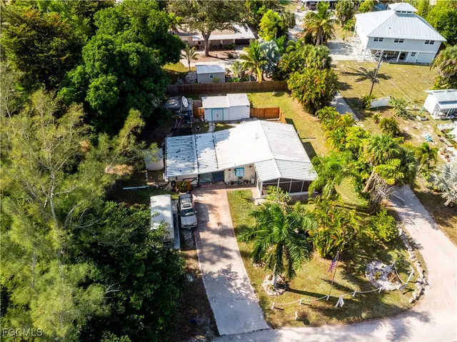a view of a house with a yard and sitting area