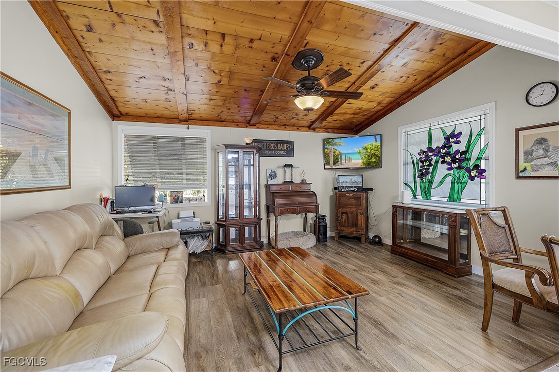15925 Quail Trail Bokeelia, FL 33922 - Photo 3 of 26 a living room with furniture and a wooden floor