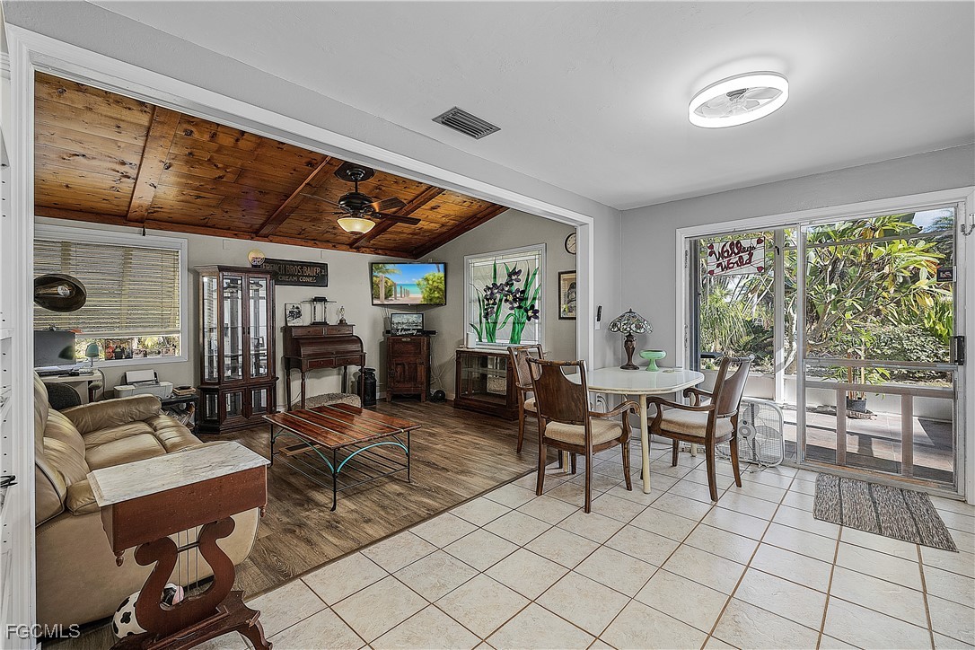 15925 Quail Trail Bokeelia, FL 33922 - Photo 7 of 26 a outdoor space with lots of tables a chair and glass door